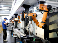 A robot is producing pump products on a production line in Ningde, Fujian province, China, on August 12, 2024. (