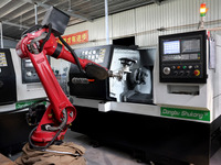 A robot is producing pump products on a production line in Ningde, Fujian province, China, on August 12, 2024. (