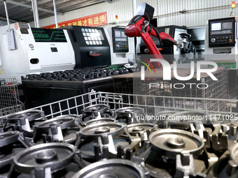 A robot is producing pump products on a production line in Ningde, Fujian province, China, on August 12, 2024. (