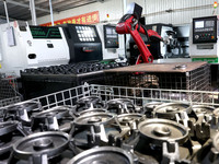 A robot is producing pump products on a production line in Ningde, Fujian province, China, on August 12, 2024. (