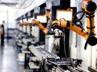 A robot is producing pump products on a production line in Ningde, Fujian province, China, on August 12, 2024. (