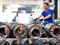 A worker is assembling water pump products at a production line in Ningde, China, on August 12, 2024. (