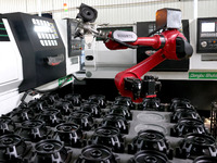 A robot is producing pump products on a production line in Ningde, Fujian province, China, on August 12, 2024. (