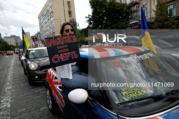 A demonstrator is holding a placard in a car during the Don't Be Silent. Captivity Kills! rally to support Ukrainian prisoners of war of the...