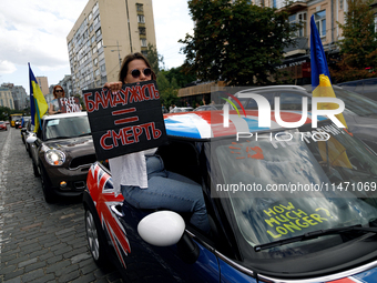 A demonstrator is holding a placard in a car during the Don't Be Silent. Captivity Kills! rally to support Ukrainian prisoners of war of the...