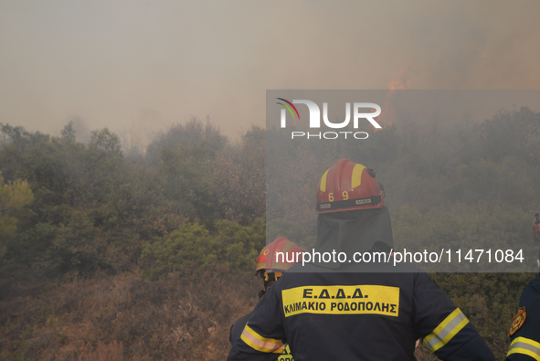 Firefighters are operating during a wildfire in Varnavas, north of Athens, on August 12, 2024. Greece is battling several wildfires on Augus...