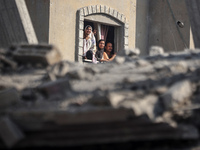 Palestinians are looking at a damaged house after an Israeli airstrike in Nuseirat, central Gaza Strip, on August 12, 2024, amid the ongoing...