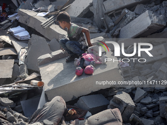 Palestinians are assessing the damage following an Israeli strike in the Nuseirat refugee camp in the central Gaza Strip on August 12, 2024,...