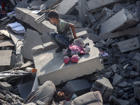 Palestinians are assessing the damage following an Israeli strike in the Nuseirat refugee camp in the central Gaza Strip on August 12, 2024,...