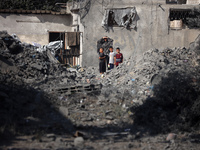 Palestinians are assessing the damage following an Israeli strike in the Nuseirat refugee camp in the central Gaza Strip on August 12, 2024,...