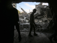 Palestinians are assessing the damage following an Israeli strike in the Nuseirat refugee camp in the central Gaza Strip on August 12, 2024,...