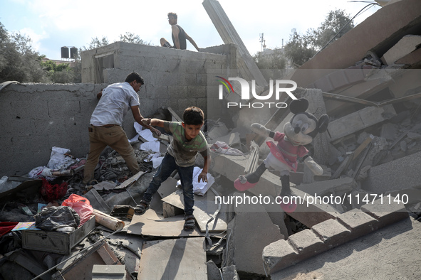 Palestinians are assessing the damage following an Israeli strike in the Nuseirat refugee camp in the central Gaza Strip on August 12, 2024,...