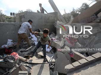 Palestinians are assessing the damage following an Israeli strike in the Nuseirat refugee camp in the central Gaza Strip on August 12, 2024,...