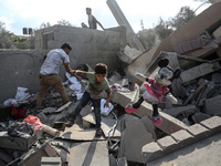 Palestinians are assessing the damage following an Israeli strike in the Nuseirat refugee camp in the central Gaza Strip on August 12, 2024,...