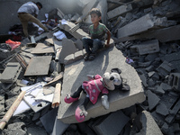 Palestinians are assessing the damage following an Israeli strike in the Nuseirat refugee camp in the central Gaza Strip on August 12, 2024,...