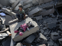 Palestinians are assessing the damage following an Israeli strike in the Nuseirat refugee camp in the central Gaza Strip on August 12, 2024,...