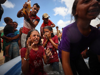 Palestinian children are playing with water and soap to cool themselves down during a heatwave at a temporary camp for the internally displa...