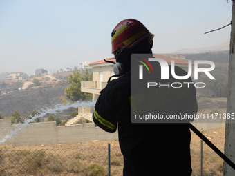 Firefighters are operating during a wildfire in Varnavas, north of Athens, on August 12, 2024. Greece is battling several wildfires on Augus...