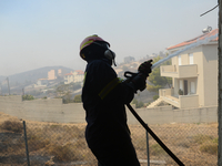 Firefighters are operating during a wildfire in Varnavas, north of Athens, on August 12, 2024. Greece is battling several wildfires on Augus...