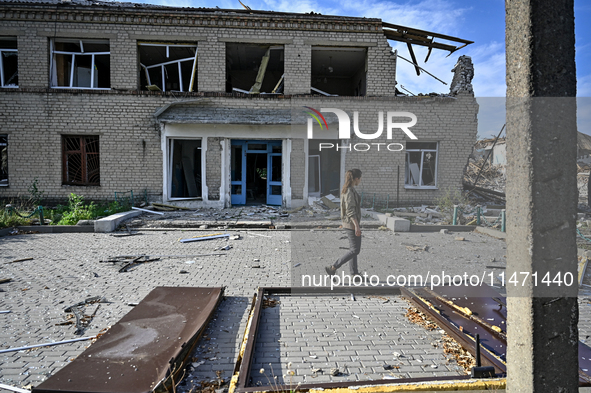 A woman is looking at the ruins of the Myrnohrad Infectious Diseases Hospital destroyed by a Russian FAB-500 bomb on July 27, 2024, in Myrno...