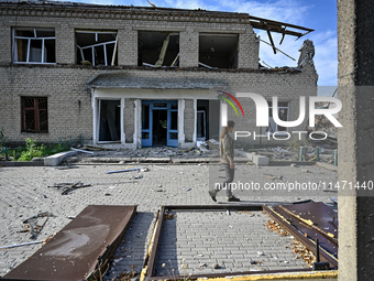 A woman is looking at the ruins of the Myrnohrad Infectious Diseases Hospital destroyed by a Russian FAB-500 bomb on July 27, 2024, in Myrno...