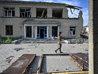 A woman is looking at the ruins of the Myrnohrad Infectious Diseases Hospital destroyed by a Russian FAB-500 bomb on July 27, 2024, in Myrno...