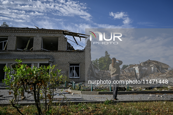 A woman is looking at the ruins of the Myrnohrad Infectious Diseases Hospital destroyed by a Russian FAB-500 bomb on July 27, 2024, in Myrno...