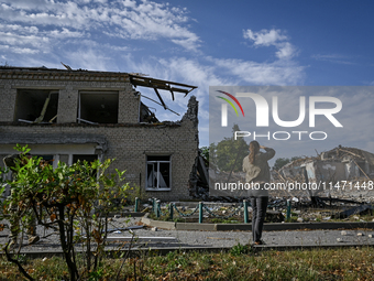 A woman is looking at the ruins of the Myrnohrad Infectious Diseases Hospital destroyed by a Russian FAB-500 bomb on July 27, 2024, in Myrno...