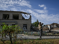 A woman is looking at the ruins of the Myrnohrad Infectious Diseases Hospital destroyed by a Russian FAB-500 bomb on July 27, 2024, in Myrno...