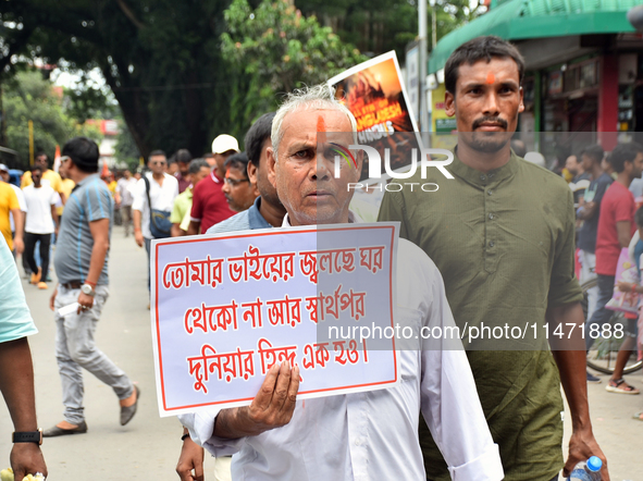 People from the Hindu community are taking part in a protest rally against the problems of the Hindu community in Bangladesh due to the unre...