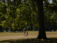 People are walking in St James's Park as the capital is being hit by a heatwave which is set to bring the temperatures to 35C, in London, En...