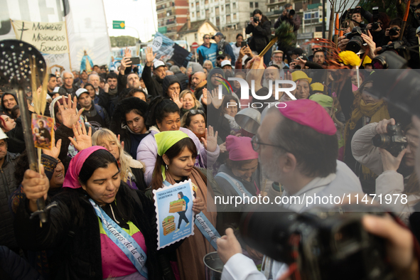 Pilgrims and workers are taking part in a march from the sanctuary at the San Cayetano Church to Plaza de Mayo Square in Buenos Aires, Argen...