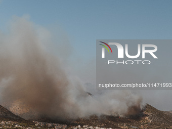 Severe wildfires are erupting across Attica, Greece, fueled by extreme heat, drought, and high winds in Neos Voutzas, Attica, Greece, on Aug...