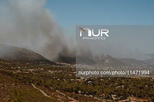 Severe wildfires are erupting across Attica, Greece, fueled by extreme heat, drought, and high winds in Neos Voutzas, Attica, Greece, on Aug...