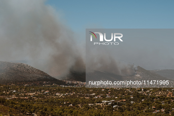 Severe wildfires are erupting across Attica, Greece, fueled by extreme heat, drought, and high winds in Neos Voutzas, Attica, Greece, on Aug...