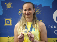 Ukrainian sabre fencer Yuliia Bakastova, who is winning gold in the Women's Sabre Team Gold Medal Match, is attending a news conference duri...