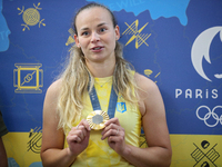 Ukrainian sabre fencer Yuliia Bakastova, who is winning gold in the Women's Sabre Team Gold Medal Match, is attending a news conference duri...