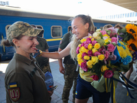 Ukrainian sabre fencer Yuliia Bakastova, who is winning gold in the Women's Sabre Team Gold Medal Match, is being greeted on the platform of...