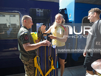 Ukrainian sabre fencer Yuliia Bakastova, who is winning gold in the Women's Sabre Team Gold Medal Match, is being greeted on the platform of...