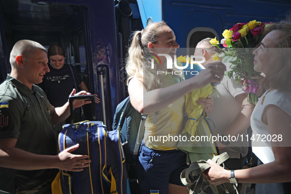 Ukrainian sabre fencer Yuliia Bakastova, who is winning gold in the Women's Sabre Team Gold Medal Match, is being greeted by her mother on t...