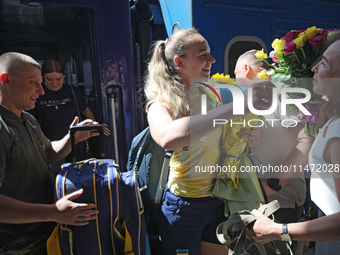 Ukrainian sabre fencer Yuliia Bakastova, who is winning gold in the Women's Sabre Team Gold Medal Match, is being greeted by her mother on t...