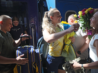 Ukrainian sabre fencer Yuliia Bakastova, who is winning gold in the Women's Sabre Team Gold Medal Match, is being greeted by her mother on t...