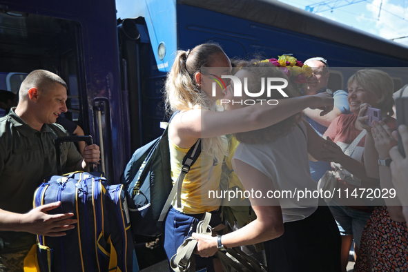 Ukrainian sabre fencer Yuliia Bakastova, who is winning gold in the Women's Sabre Team Gold Medal Match, is being greeted by her mother on t...