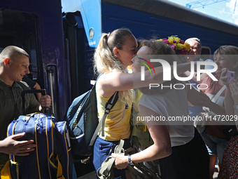 Ukrainian sabre fencer Yuliia Bakastova, who is winning gold in the Women's Sabre Team Gold Medal Match, is being greeted by her mother on t...