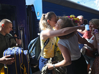 Ukrainian sabre fencer Yuliia Bakastova, who is winning gold in the Women's Sabre Team Gold Medal Match, is being greeted by her mother on t...