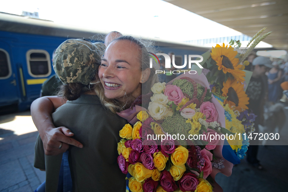 Ukrainian sabre fencer Yuliia Bakastova, who is winning gold in the Women's Sabre Team Gold Medal Match, is being greeted on the platform of...