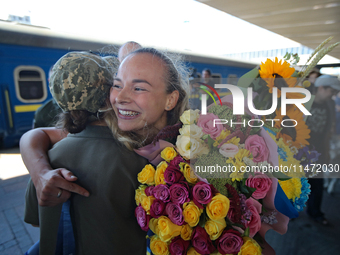 Ukrainian sabre fencer Yuliia Bakastova, who is winning gold in the Women's Sabre Team Gold Medal Match, is being greeted on the platform of...