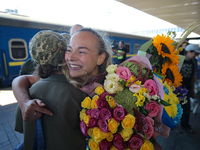 Ukrainian sabre fencer Yuliia Bakastova, who is winning gold in the Women's Sabre Team Gold Medal Match, is being greeted on the platform of...