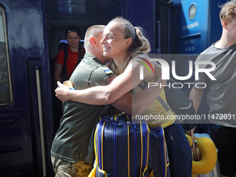 Ukrainian sabre fencer Yuliia Bakastova, who is winning gold in the Women's Sabre Team Gold Medal Match, is being greeted on the platform of...