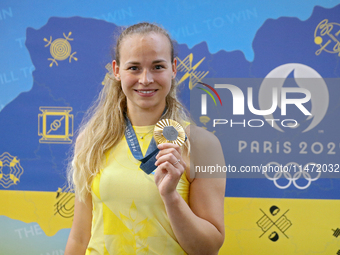 Ukrainian sabre fencer Yuliia Bakastova, who is winning gold in the Women's Sabre Team Gold Medal Match, is attending a news conference duri...